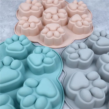 KittyNook Cat Co. Paw Print Silicone Baking Molds in pink, blue & gray—non-stick molds for treats or desserts.